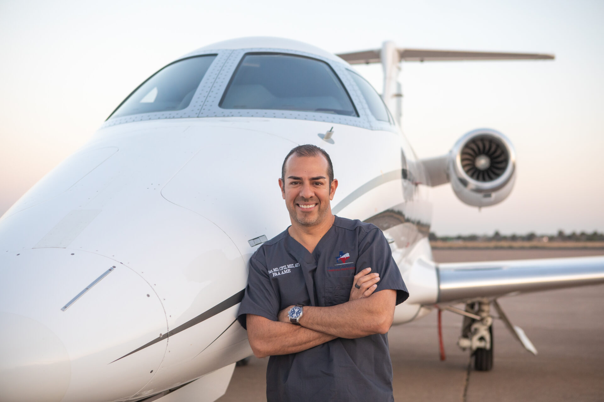 A man standing in front of an airplane.